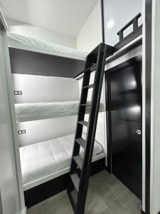 a bunk bed room with a ladder and bunk beds at Cotrades 1 En San Blas-Canillejas in Madrid
