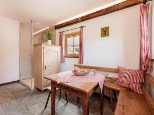 a kitchen with a table and a bowl of fruit on a table at MYALPS Mühlhof inklusive Sauna in Oetz +29 photos