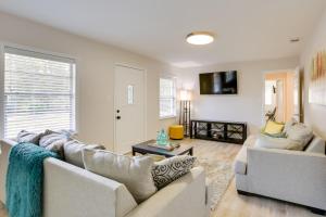 a living room with two couches and a tv at Chic Tallahassee Vacation Rental Near Universities in Tallahassee