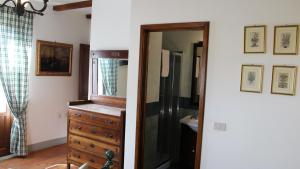 baño con espejo y tocador de madera en Agriturismo Borgo Santa Lucia, en Castiglion Fiorentino