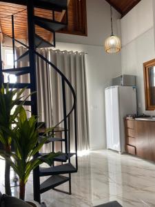 uma cozinha com uma escada em espiral e um frigorífico em Gramado Centro 3 Hospede Loft 2 em Gramado