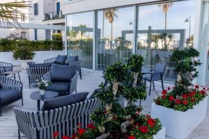 a patio with chairs and flowers on a building at EUROPA Hotel in Vasto