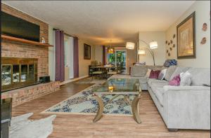 a living room with a couch and a fireplace at Family launchpad in Asheville