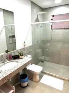 a bathroom with a shower and a toilet and a sink at Canto Alemão in Domingos Martins