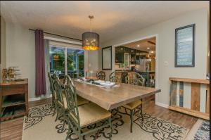 a dining room with a table and chairs at Family launchpad in Asheville