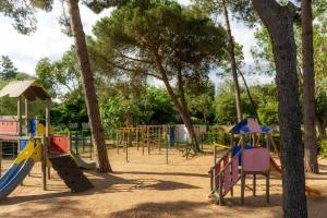 a playground with a bunch of play equipment at Camping Campo Di Liccia in Bonifacio