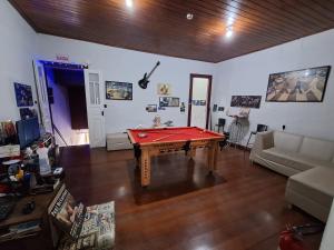 a living room with a pool table in it at La Musica Hostel OuroPreto in Ouro Preto