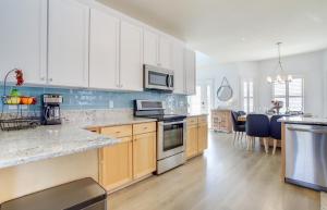 a kitchen with white cabinets and a counter top at 4 Mi to Bethany Beach Frankford Getaway with Pool! in Frankford