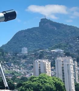 a mountain with a cross on top of a city at Panorama Inn in Rio de Janeiro