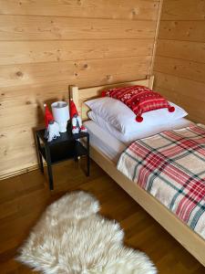 a bedroom with a bed and a table with a rug at Domek JAWOR in Zakopane