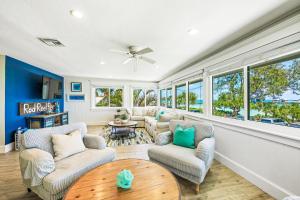 a living room with couches and a table at Bay Vista at Bayside Bungalow in Anna Maria