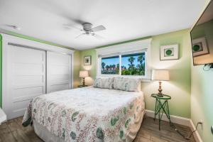 a bedroom with a bed and a window at Bay Vista at Bayside Bungalow in Anna Maria