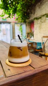 a drink sitting on top of a wooden table at Alaca Butik Otel in Cesme