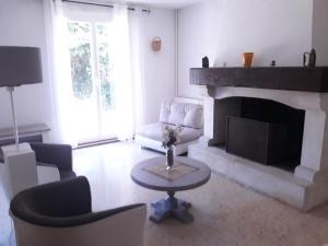 a living room with a couch and a fireplace at GITE EN PROVENCE in Istres