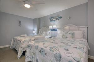 a bedroom with a bed with a comforter on it at 2501 S Ocean Blvd, 1127 - Ocean View Sleeps 6 in Myrtle Beach