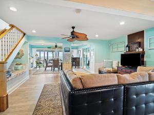 a living room with a couch and a ceiling fan at Oakwood Beach - Lake Front - Geneva-On-The-Lake in Ashtabula