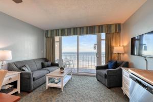 a living room with a couch and a television with a view at 2501 S Ocean Blvd, 0505 - Ocean Front Sleeps 6 in Myrtle Beach