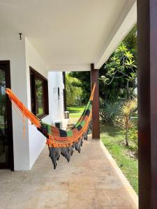 a hammock hanging from the side of a house at Taiba Beach Resort in Taíba
