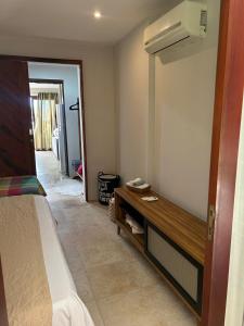 um quarto com uma cama e um banco de madeira em Taiba Beach Resort em Taíba