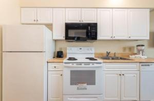 a white kitchen with a stove and a refrigerator at 2501 S Ocean Blvd, 0707 - Ocean Front Sleeps 6 in Myrtle Beach