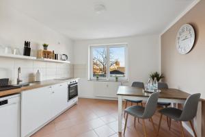 a kitchen with a table and chairs and a dining room at *NulandtApartment* #2 in Merseburg
