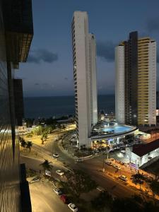 a view of a city with tall buildings and a street at Ilusion Flat Ponta Negra in Natal