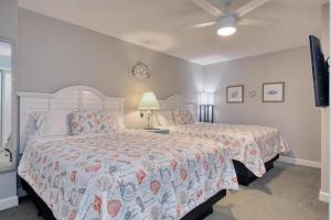 a bedroom with two beds and a ceiling fan at 2501 S Ocean Blvd, 1017 - Ocean View Sleeps 6 in Myrtle Beach