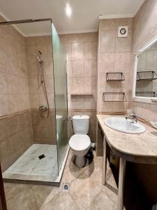 a bathroom with a shower and a toilet and a sink at Apartments in Panorama Beach Vigo Nessebar in Nesebar