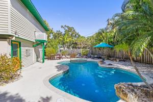 a swimming pool in the backyard of a house at Mangoes on Magnolia in Anna Maria