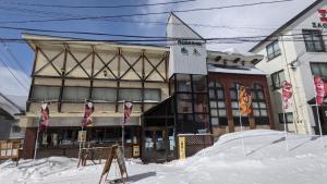 a building with a pile of snow in front of it at オーベルジュ樹氷 in Yamagata