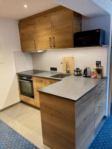 a kitchen with wooden cabinets and a counter top at Alkira in Sankt Anton am Arlberg
