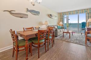 a dining room and living room with a table and chairs at 2501 S Ocean Blvd, 0211 - Ocean Front Sleeps 8 in Myrtle Beach