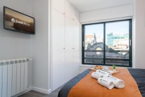 a bedroom with a bed and a large window at Host Wise - Elegant Spacious Flat w Balcony - Ace Location in Vila Nova de Gaia +20 photos