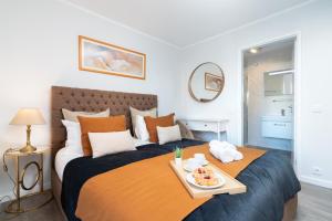 a bedroom with a bed with a tray of food on it at Host Wise - Elegant Spacious Flat w Balcony - Ace Location in Vila Nova de Gaia
