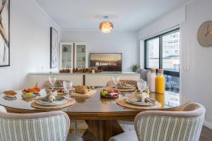 a dining room with a table with food on it at Host Wise - Elegant Spacious Flat w Balcony - Ace Location in Vila Nova de Gaia