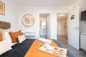 a room with a bed with a tray of food on it at Host Wise - Elegant Spacious Flat w Balcony - Ace Location in Vila Nova de Gaia