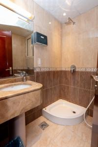 a bathroom with a sink and a bath tub at Burj Al Balad Hotel in Mecca +12 photos