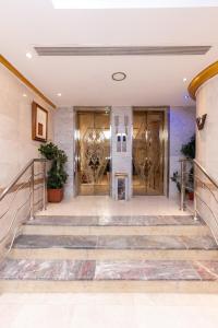 a pair of doors in a building with stairs at Burj Al Balad Hotel in Mecca