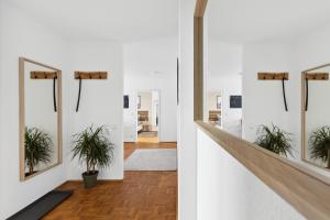 a hallway with potted plants on the wall at Apartment Oase for Four in Merseburg