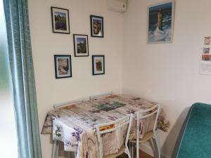a table in a room with pictures on the wall at ACCUEIL LAFAYE21 in Orthez