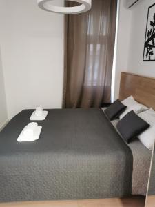 a bedroom with a bed with black and white pillows at BG Exclusive Apartment in Belgrade