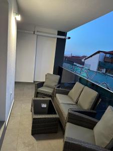 a balcony with a couch and chairs on a building at Apartament de Lux André in Sibiu