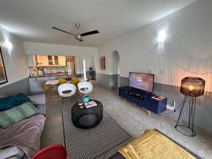 a living room with a couch and a tv at Santorini - Kallisti 25, Ballito Family only in Ballito