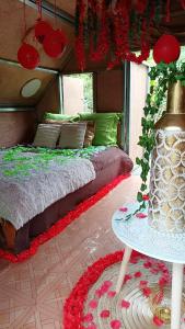 a bedroom with a bed and a table with flowers at CAMPING le fruit de la passion in Saint-Louis +22 photos
