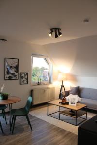 a living room with a couch and a table at No2 by 21 Apartments in Kaarst +15 photos