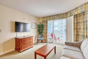 a living room with a tv and a couch and a table at 2501 S Ocean Blvd, 1115 - Ocean View Sleeps 8 in Myrtle Beach