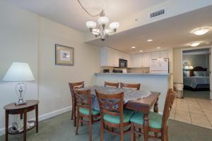 a dining room and kitchen with a table and chairs at 2501 S Ocean Blvd, 1115 - Ocean View Sleeps 8 in Myrtle Beach