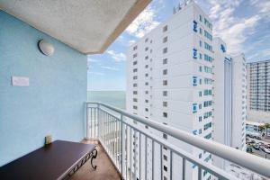 a balcony with a table and a white building at 2501 S Ocean Blvd, 1115 - Ocean View Sleeps 8 in Myrtle Beach