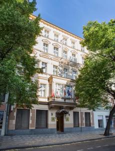 a large white building with a balcony at Hotel Tyl in Prague
