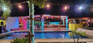 a pool at night with a bar in the background at Hacienda San Miguel in Tlayacapan